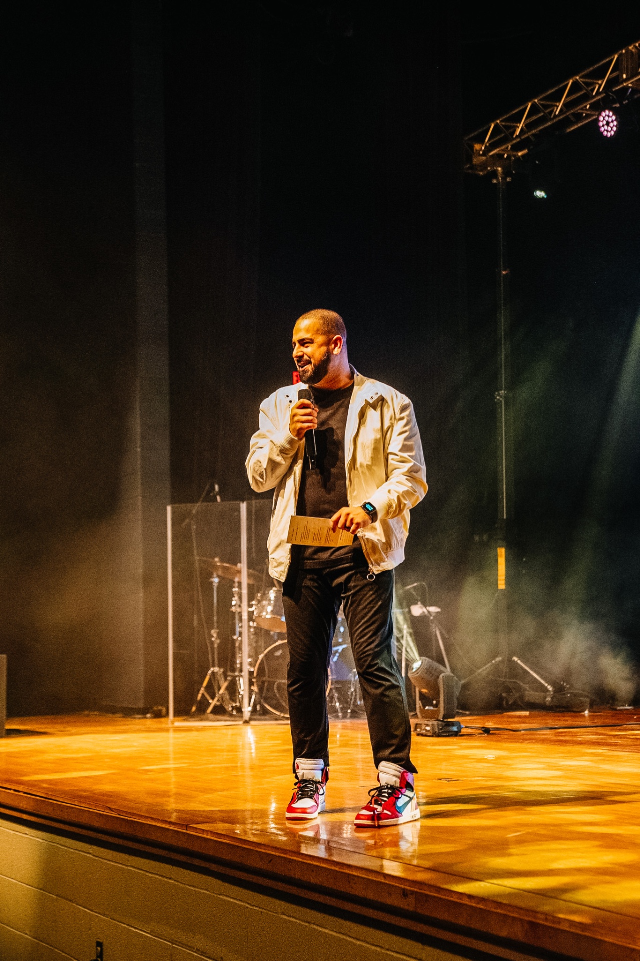Matt Perry speaking on stage at a conference